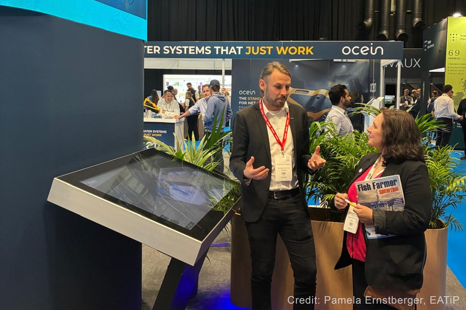 A photo from Aquaculture UK of William Lindborg (Framo) talking to Pamela Ernstberger (EATiP).